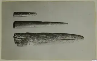 Three tapering, pointed find objects of different lengths, photographed on a pale backdrop, from Petra tou Limniti.