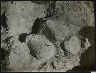 Excavated soil with rock blocks and a broken vessel lying among the stones at Ayios Iakovos