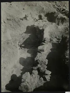 Excavation trench at Ayios Iakovos with a line of rough stones running through the dug soil