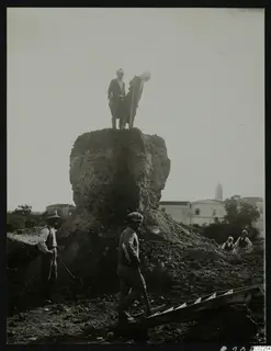 Mound called Bamboula being torn down at Kition, with two men on top and workers standing below