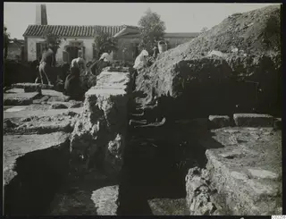 Excavation at Kition showing rooms 10 to 4 and working people among exposed stone walls