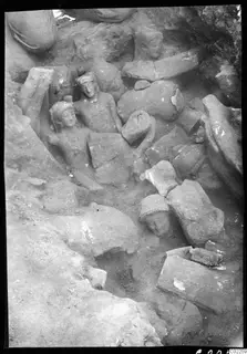 Accumulation of stone statues and heads lying together in an excavated corner at Kition