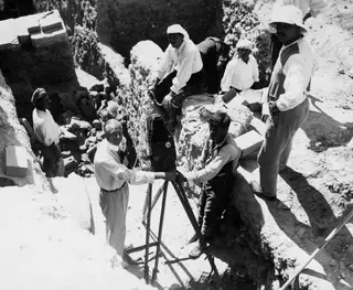 John Lindros filming at the excavation in Kition, with a large camera on a tripod and workers on the trench edges