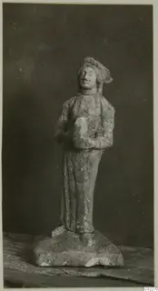 Small limestone figurine of a standing figure in a cap and long garment, from Vouni