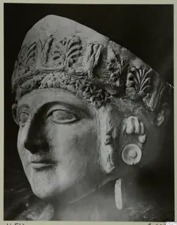 Head of a figure wearing a tall headdress with carved leaf decoration, from Vouni