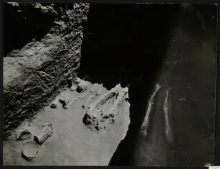 Skeleton and pottery vessels during excavation of a tomb at Amathus