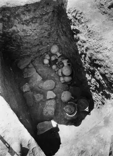 Tomb 19 at Amathus with pottery vessels lying in situ on the floor among scattered stones