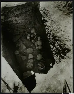 Finds in situ in Tomb 19 at Amathus: jugs, juglets and bowls lying among stones at the bottom of a cut.