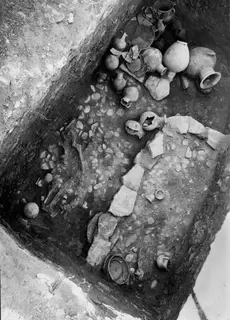 Tomb 22 at Amathus with pottery vessels and fragmentary human bones lying in situ on the tomb floor.