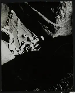 Skeleton and pottery vessels in a rock-cut tomb at Amathus during excavation
