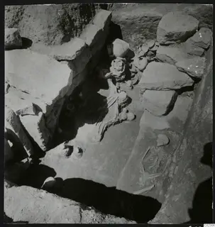 Skeletons and vessels during excavation of a tomb at Amathus, seen from above