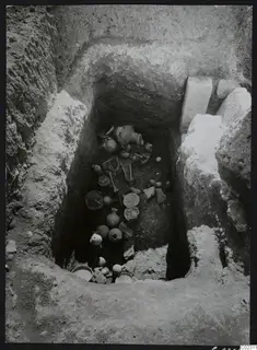 Tomb 23 at Amathus seen from above, with pottery vessels and skeletal bones lying on the tomb floor