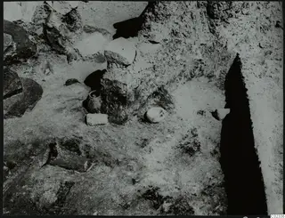 Excavation at Kythrea with small vessels and stones lying on the excavated ground