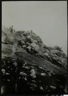 Rocky hillside at Petra tou Limniti with one person standing among the stones near the top