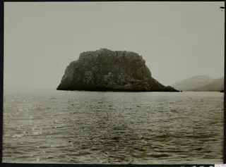 Petra tou Limniti, a rocky island rising from the sea, seen from the west.