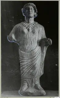 Limestone statue of a standing draped figure with curled hair and a necklace, from Vouni