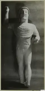Limestone statue of a bearded standing male figure from Kition, one arm raised