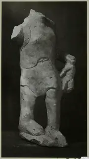 Limestone statue fragment of a standing figure, headless, legs and feet on a rough base, from Kition.