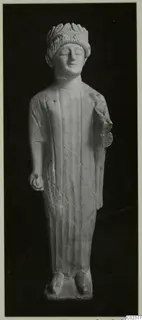 Limestone statue of a standing figure with closed eyes and a head covering, Limestone Cypro-Greek II