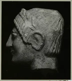 Limestone head in profile facing left, from Kition, with ridged hair bands and a carved ear