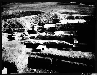 Excavated area at Bamboula with exposed stone walls, trench faces and spoil heaps after digging.