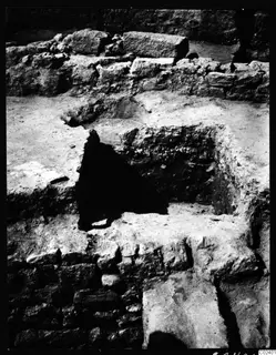 Excavated stone walls and a broken floor opening in Room 4 at Kition