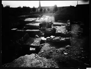 Excavated stone walls and flat stone blocks in trenches at Kition, Bamboula, photographed from the east