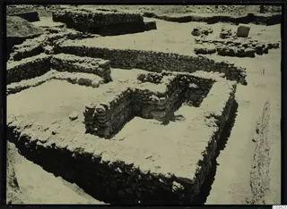 Excavated rubble stone walls at Ayia Irini, with a spoil heap at the upper left
