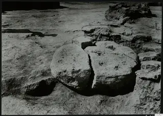 Excavation at Ayia Irini with two large rounded stone blocks in situ and rubble stones around them