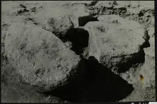Large worked stone blocks lying in excavated ground at Ayia Irini