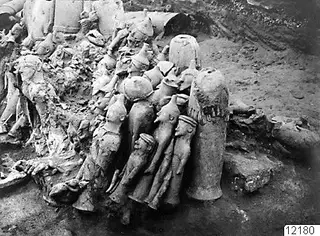 Terracotta figurines and vessels in situ in an excavated square at Ayia Irini