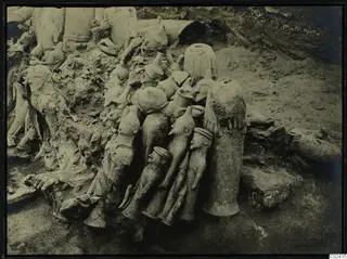 Excavation of Ayia Irini, square K 10,11, with a crowded cluster of clay figures lying in situ in the soil.