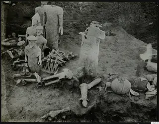 Excavation at Ayia Irini with pale figures and bones found in situ among broken pottery