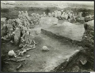Excavation trench at Ayia Irini with terracotta figures and bones lying in situ