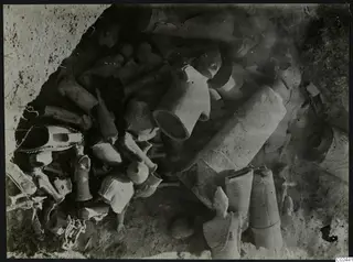 Clay figurines and fragments lying in situ in excavated soil at Ayia Irini