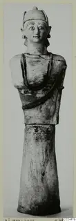 Terracotta Neo-Cypriote statue of a figure with a cap-like headdress and a bust on a tall flaring base, from Ayia Irini
