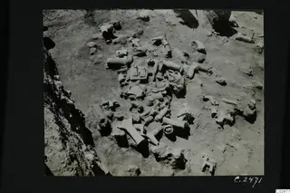 Excavated ground at Ayia Irini, squares K-L 6, with many broken terracotta figurines and fragments lying in situ.