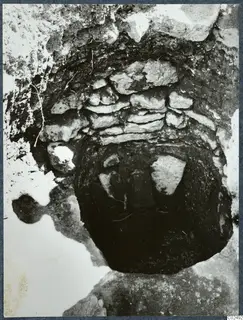 Tomb chamber at Enkomi seen from above, with a stone-built wall and dark opening