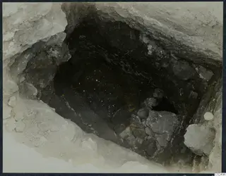 Tomb 12 at Enkomi: view down into the tomb chamber, with stones piled against one side during excavation