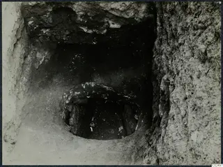 Tomb 13 at Enkomi during excavation, with a tomb chamber opening and stones at its entrance