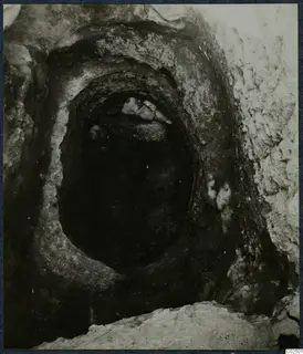 Tomb chamber opening at Enkomi, with stones lying in the entrance during excavation