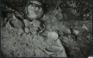 Tomb 17 at Enkomi: tomb chamber floor during excavation, with a painted jar and bone fragments among finds in situ