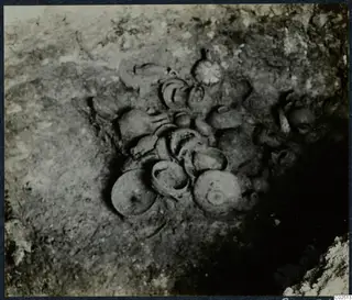 Tomb 13 at Enkomi during excavation, with a cluster of vessels lying in the soil of the tomb chamber