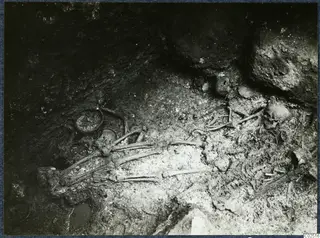 Skeleton and skulls in the chamber of Tomb 18 at Enkomi during excavation