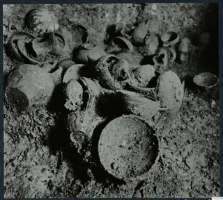 Pottery vessels lying in soil inside Tomb 13 at Enkomi during excavation
