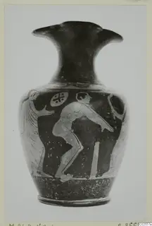 Pottery jug with a trefoil mouth, its dark body painted with pale figures of a bending man and a winged figure