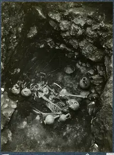 Tomb 14 at Enkomi, tomb chamber with a skeleton and pottery vessels during excavation
