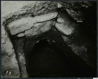 Tomb 7 at Enkomi: stone slabs laid across the entrance of a tomb chamber during excavation