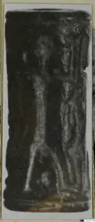 Cylinder seal from Enkomi with carved figures, photographed upright against a pale card.