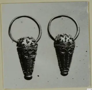 Two gold pendants with plain wire loops and dotted conical bodies, shown side by side
